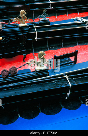 Detail view of decorative brass horse figurines on gondolas in canal in Venice Stock Photo