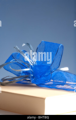 present - luxury gift box decorated with blue ribbon on gray background Stock Photo