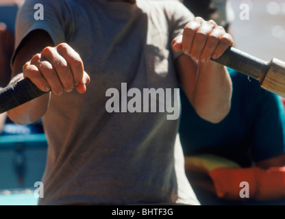 Hands and oars of oarswoman rowing Grand Canyon Dory on the Colorado River Stock Photo