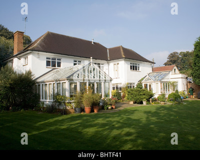 Large detached traditional white house with conservatory extension Stock Photo