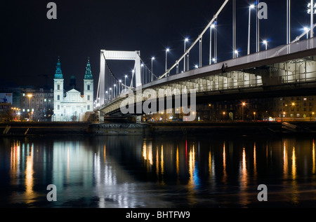 The inner city parish church and Elizabeth Bridge in Budapest at night Stock Photo