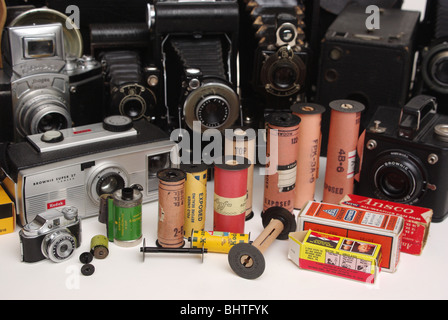 Vintage film of many different formats and makes (Kodak, Agfa and others) along with cameras it was found in (Brownie, Agfa, folding and box-type). Stock Photo