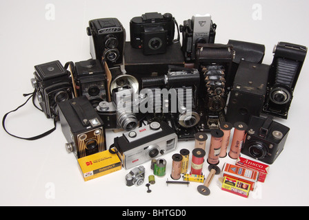 Vintage film of many different formats and makes (Kodak, Agfa and others) along with cameras it was found in (Brownie, Agfa, folding and box-type). Stock Photo