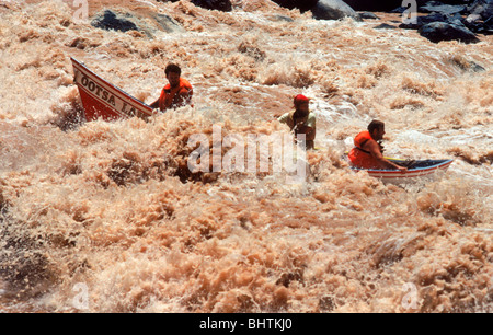 Adventure travelers in Grand Canyon Dory bouncing through churning and twisting rapids at Lava Falls on Colorado River Stock Photo