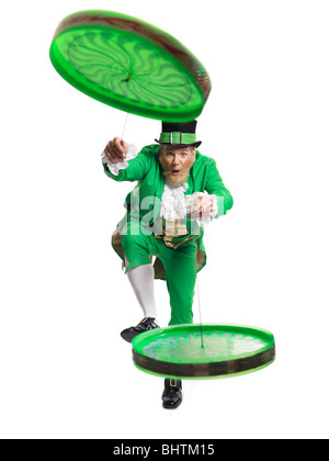 Cheerful Leprechaun playing with two flip n flyers isolated on white background Stock Photo