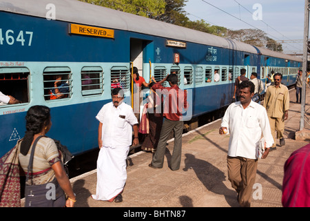 India, Kerala, Kollam Junction Railway Station, passengers on platform boarding train Stock Photo