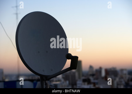 satellite television receiving dish on rooftops in the evening buenos aires argentina Stock Photo