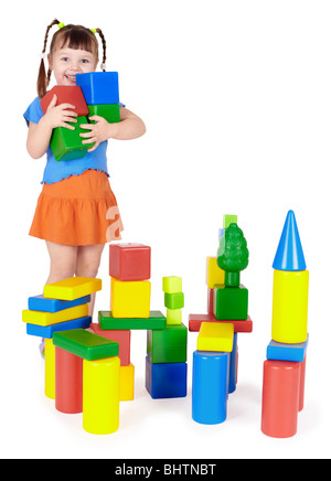 Happy child builds a castle out of color blocks Stock Photo