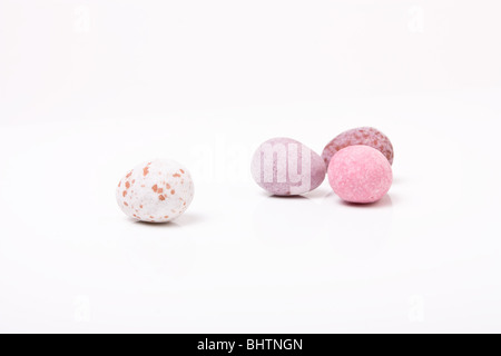 Candy covered small chocolate easter eggs from low viewpoint against white background. Stock Photo