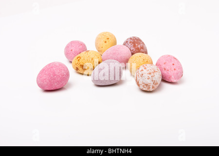 Candy covered small chocolate easter eggs from low viewpoint against white background. Stock Photo