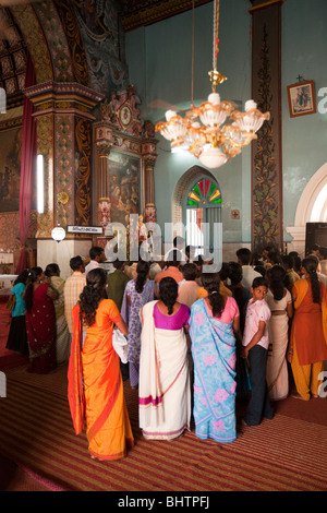 India, Kerala, Champakulam village, Syrian Christian Church interior, christening service in progress Stock Photo