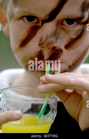 Boy Wearing Cam Cream Drinking Orange Stock Photo