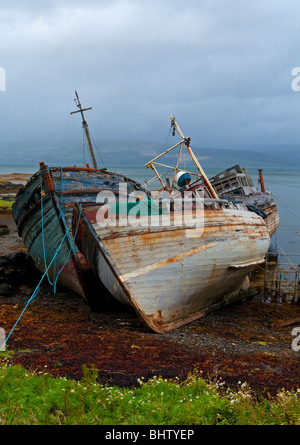 Shipwrecked decommissioned inshore fishing boats on the beach at Salen near  Tobermory Isle of Mull Inner Hebrides Scotland UK Stock Photo