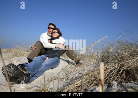 A couple in love amidst the dunes Stock Photo