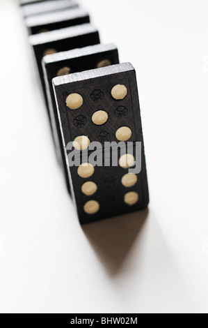 Dominoes in a line on a white background shot from above Stock Photo