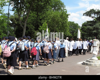 Scouts in Catholic procession in Bois de Boulogne garden, Paris, France Stock Photo