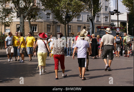 Colourful People wearing straw hats and a sombrero walking up Las Ramblas  in Barcelona Spain Stock Photo