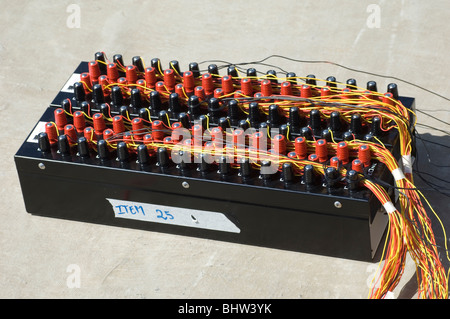 Professional fireworks launching box with red and black fuses connected with colourful wires Stock Photo