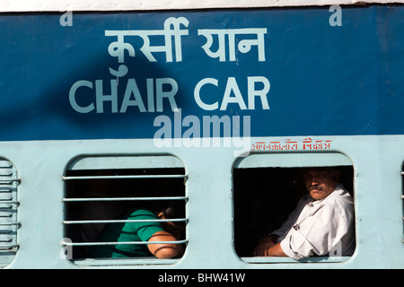 Southern, India, Kerala; Kollam Railway Station, passengers in second class chair car carriage windows Stock Photo