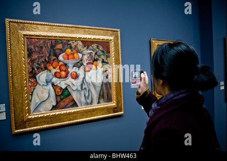 Paris, France - Woman Tourist Taking photos of French Post-Impressionists Painting, Cezanne,  Inside of Orsay Museum, Musee d'orsay, fine art, french still life painting food, girl musée orsay Stock Photo