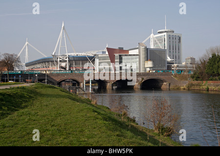 Cityscape view of Cardiff' Millennium Stadium, Wales UK and Railway Bridge over the river Taff Cardiff city centre skyline British city Stock Photo