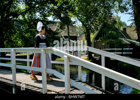 The Netherlands, regional costume, Volendam, girl, wooden shoes, Dutch, Holland, fishing village, bridge, water Stock Photo