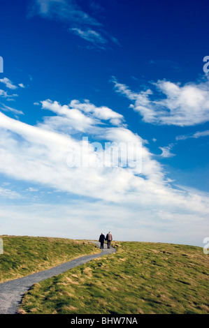 elderly couple walking on path Stock Photo