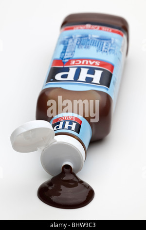 Plastic bottle of HP brown sauce spilling onto a white surface Stock Photo