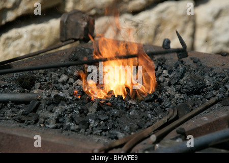 Blacksmith using traditional method of forging iron Stock Photo