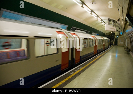 Underground train coming into Paddington tube station, London UK Stock Photo