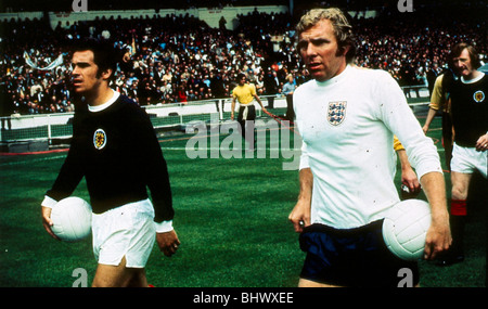 Bobby Moncur Scotland football player captain May 1971 Leads out teams with Bobby Moore England captain British Home International match Wembley Stadium London. Bob Moncur leads out Scotland alongside Bobby Moore of England for the Auld Enemy clash at Wembley in 1971. A crowd of 100,000 saw the match end in a 3-1 English victory. Stock Photo