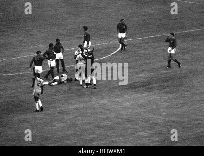 International Football July 1966 Brazil v Portugal World Cup 1966 Group Phase Pele lies injured on floor Stock Photo