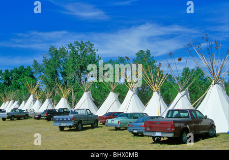 Vehicles parked at tipis during annual Crow Fair at Crow Agency, Montana, USA Stock Photo