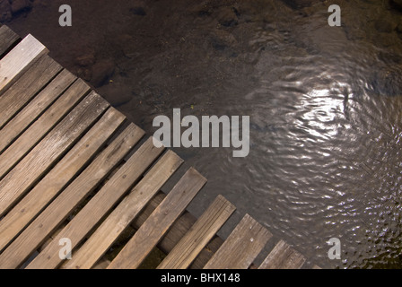 A wooden walkway over a river in the Drakensberg Mountains of Kwazulu Natal, South Africa Stock Photo