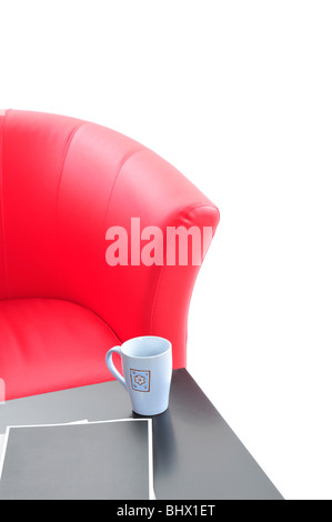 Red armchair and black table isolated on the white background. Stock Photo