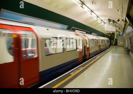 Underground train coming into Paddington tube station, London UK Stock Photo