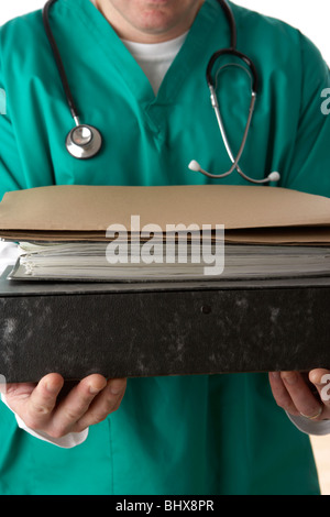 man wearing medical scrubs and stethoscope holding a stack of files and paperwork Stock Photo