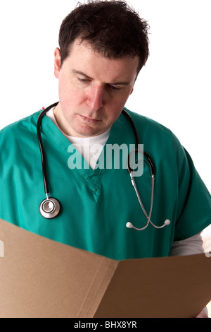 man wearing medical scrubs and stethoscope reading notes in a brown folder Stock Photo
