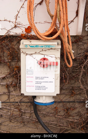 An electric powerpoint on a fishermans shed on the beach in Aldeburgh , Suffolk , England , Britain , Uk Stock Photo