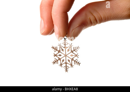 hand holding silver snow flake Stock Photo