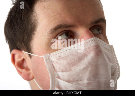 man wearing wearing medical face mask looking up Stock Photo