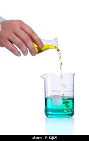 Hand pouring liquid into flak over white background Stock Photo