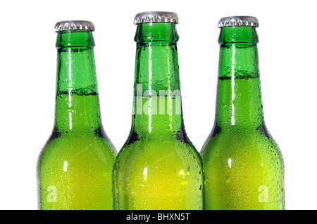 Three green beer bottles isolated on white background - Selective focus on front bottle Stock Photo