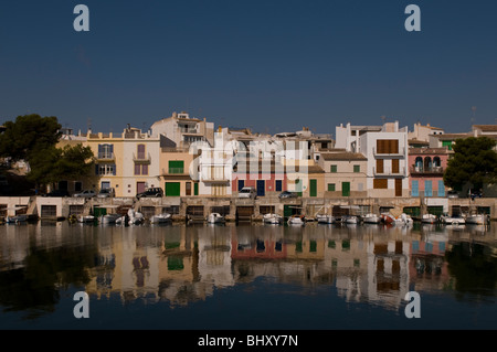 View of colored houses and white fishing boats with there reflections in water. Stock Photo