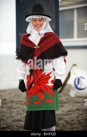 a young woman dressed in traditional costume at the Welsh Lady charity sponsored fun run, St Davids Day, Aberystwyth Wales UK Stock Photo