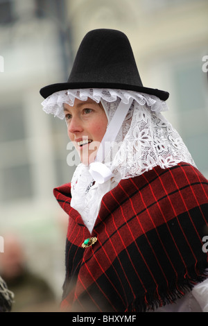 a young woman dressed in traditional costume at the Welsh Lady charity sponsored fun run, St Davids Day, Aberystwyth Wales UK Stock Photo