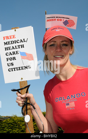 Free healthcare in the USA must go female protester holding a demonstration notice board Stock Photo