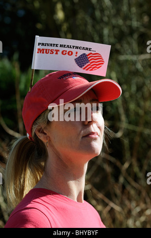 Private healthcare in the USA must go female protester wearing a flag in her cap Stock Photo
