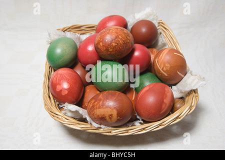 Multicoloured Easter eggs in the basket. Stock Photo