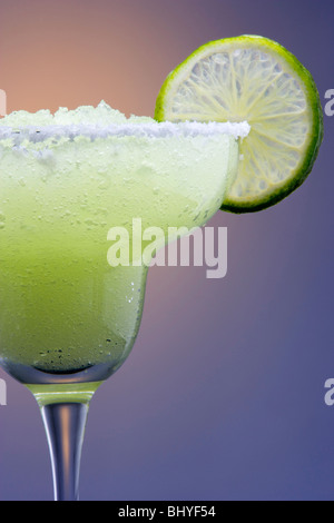 Frozen Margarita with Lime Garnish on Highlighted Background Stock Photo